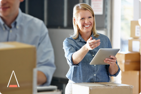 Smiling Woman Uses StandardPay on Her Tablet with Right Hand Reaching Out