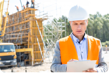 Man Manages Payment Information In Front of Construction Site