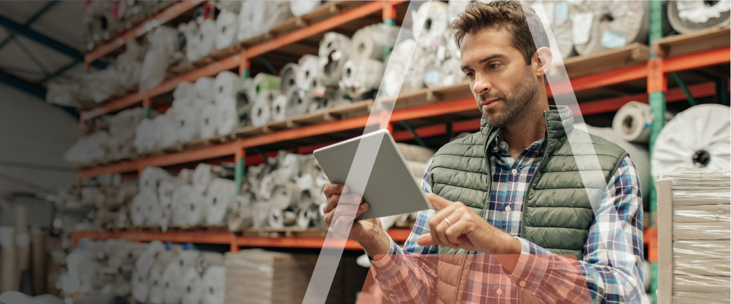 Man in a Warehouse Uses StandardPay on His Tablet